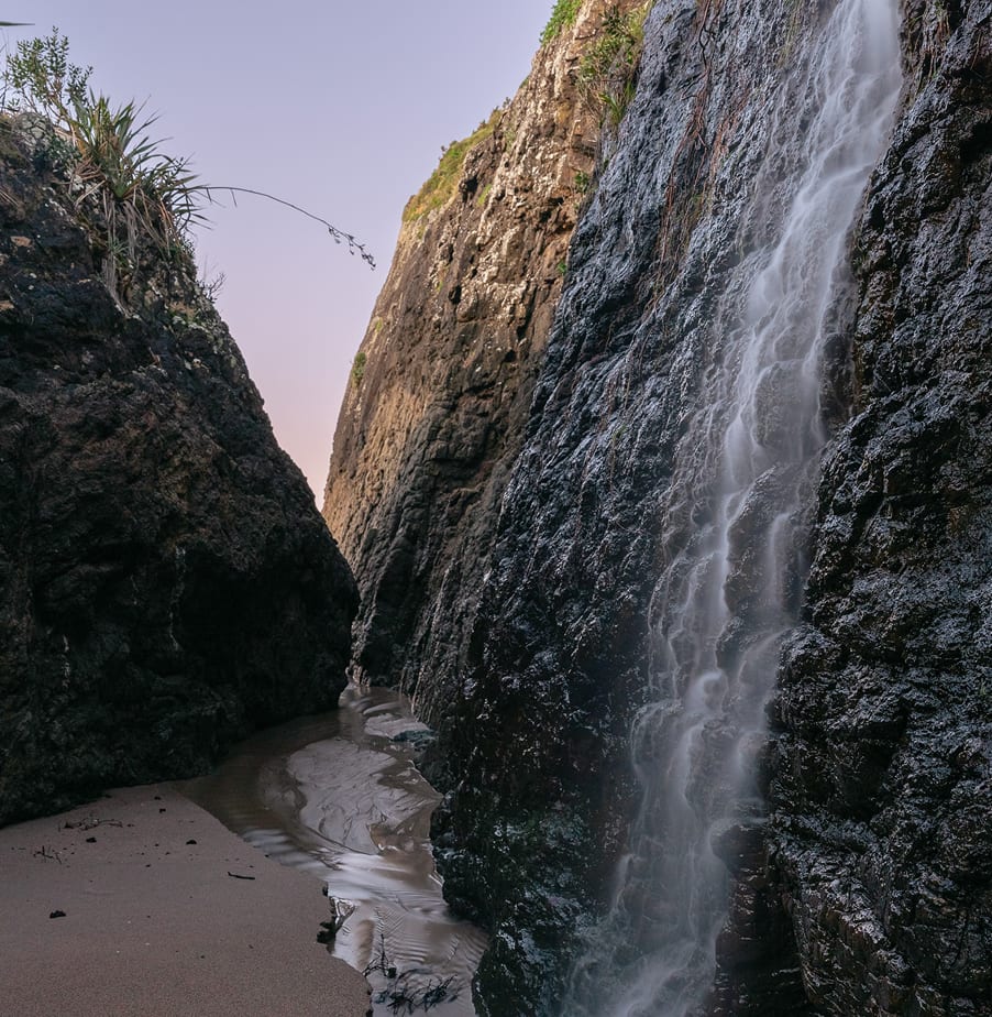 Freshwater cascade through coastal cliffs — a hidden feature of the private beaches