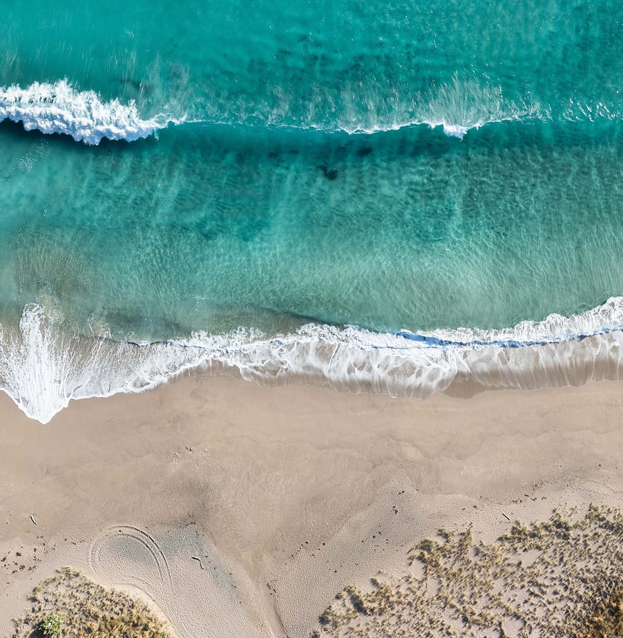 Turquoise Pacific surf from above — a private beach at Mataka Station