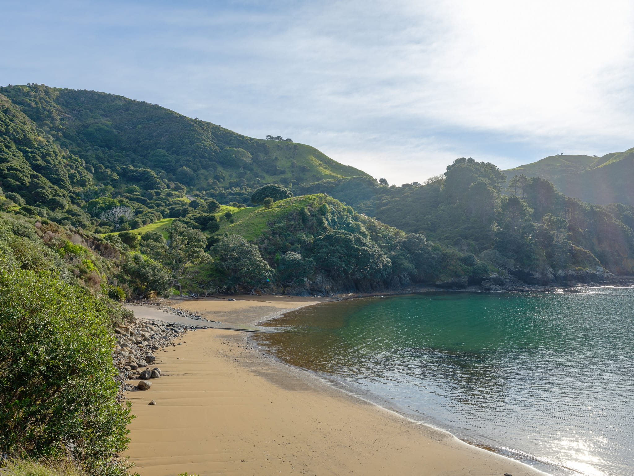 A sheltered cove below bush-covered hills on the conservation estate