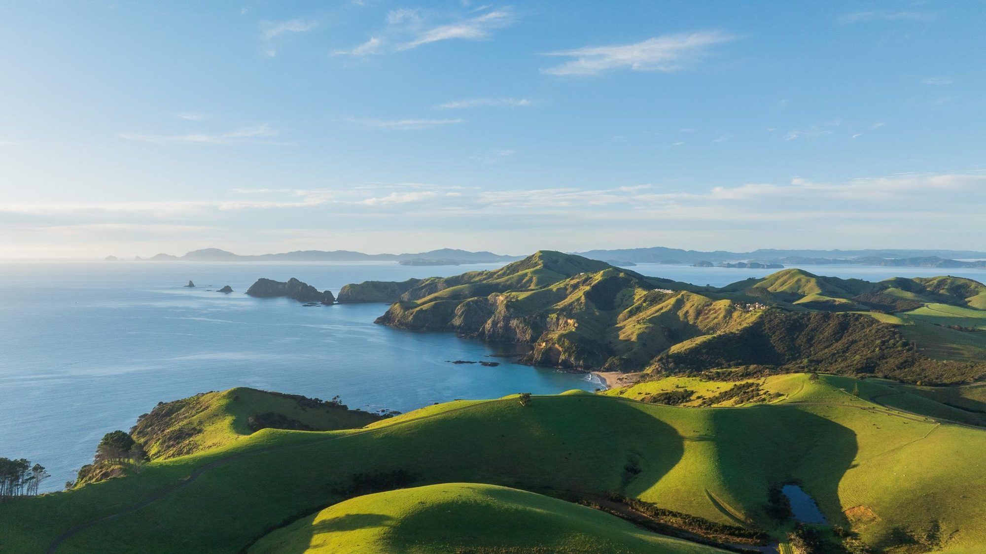 Aerial view of Mataka Station's green headlands and the Bay of Islands