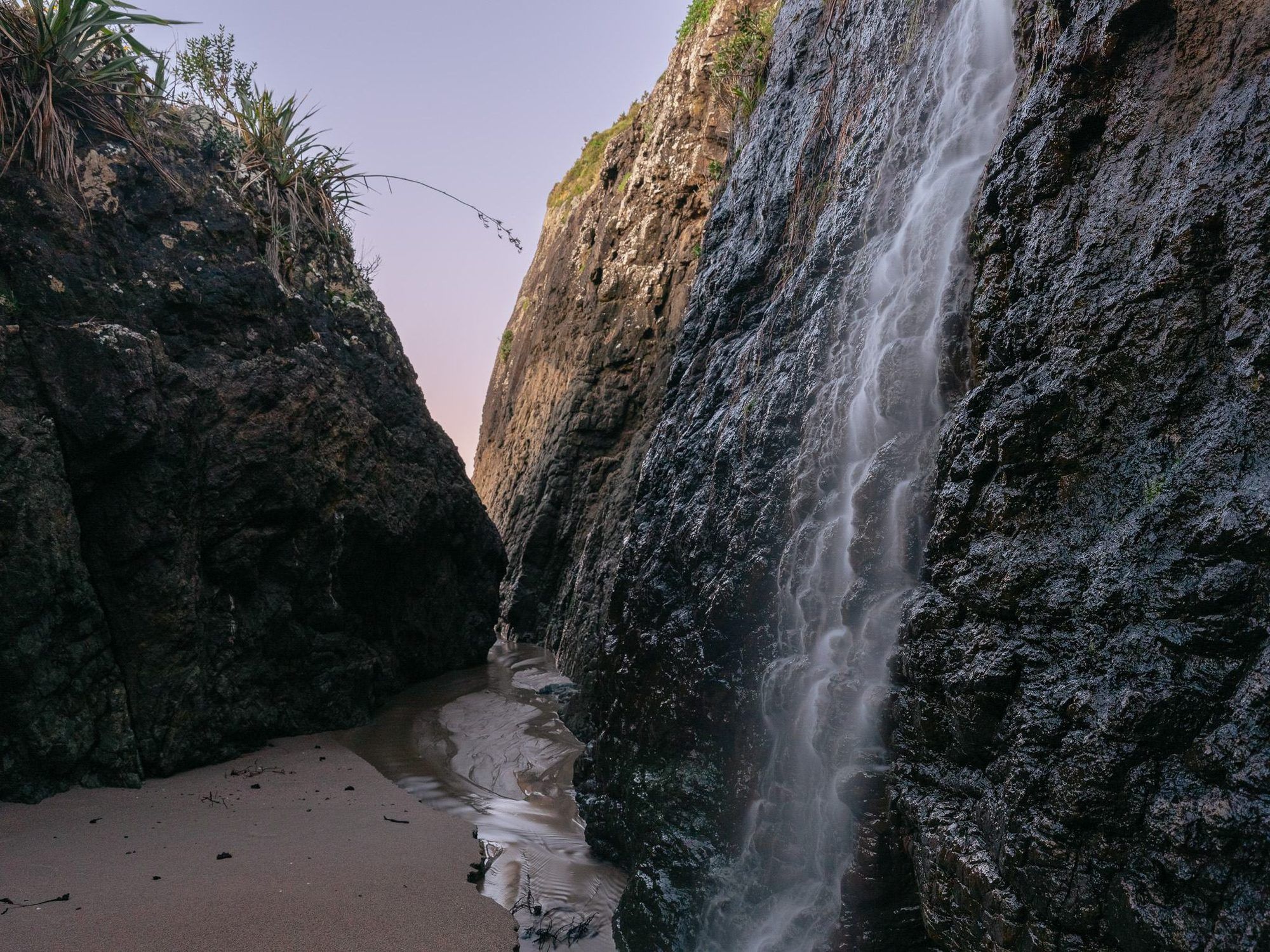 Waterfall falling to the sand on a Mataka beach